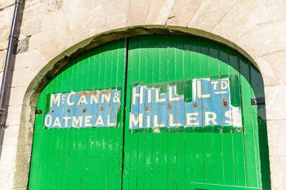 Green door with sign 'McCann & Hill Ltd Oatmeal Millers' at former McCann & Hill mill, Merchant's Quay, Drogheda.