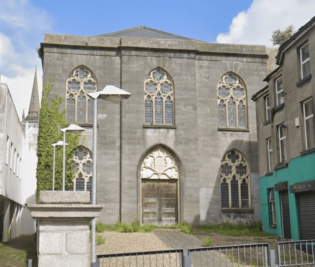 A photograph of a grey-bricked church.