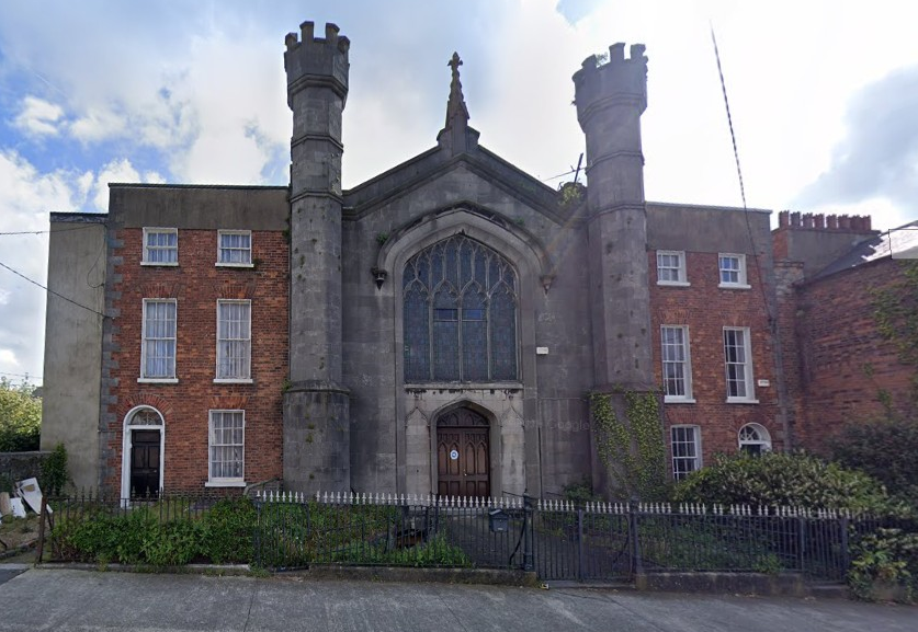 A photograph of a Presbyterian church, with two "turrets" on each side.