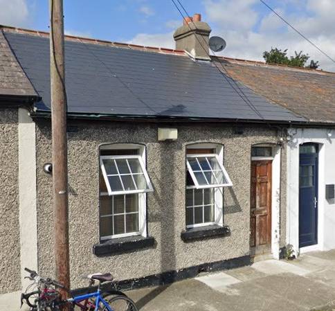 A cottage with two front windows and a door